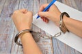 Woman in handcuffs. To sign a guilty verdict. The conviction and prison sentence. Royalty Free Stock Photo