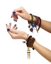Female hands with handmaid bijouterie bracelets. Nails with blue manicure