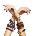 Female hands with handmaid bijouterie bracelets. Nails with blue manicure