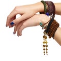 Female hands with handmaid bijouterie bracelets. Nails with blue manicure