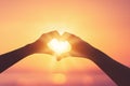 Female hands heart shape on sunset sky at tropical beach abstract background. Copy space of happy love travel and freedom in Royalty Free Stock Photo