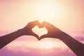 Female hands heart shape on sunset sky at tropical beach abstract background. Copy space of happy love travel and freedom in Royalty Free Stock Photo