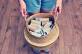 Female hands hold a basket with empty rolls of finished toilet paper. Cardboard recycling and reuse concept. Problems with toilet Royalty Free Stock Photo