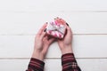 Female hands hold box wrapped in pink paper with bow Royalty Free Stock Photo