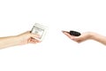 Female hands hold car keys and stack of dollars on white background. Royalty Free Stock Photo