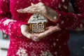 Female hands hold a Christmas painted gingerbread in the form of a house. Royalty Free Stock Photo