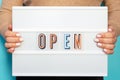 Female hands hold lightbox with the inscription open close-up