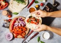 Female hands hold mexican tacos on concrete background. Cooking.