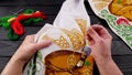 Female hands hold a needle with a thread and a hoop to fix the fabric in the process of embroidering of towel Royalty Free Stock Photo