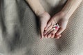 Female hands hold and offer two choice medicine pills capsule for chosen. White and pink candy or meds compare to choose from. Royalty Free Stock Photo