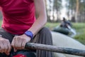 Female hands hold a paddle in an inflatable boat, in the channels between lakes, against a blurred background. Morning Royalty Free Stock Photo