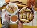 Female hands hold ready made freshly baked homemade croissants on the background of a kitchen cutting board. Food kitchen Royalty Free Stock Photo