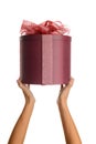 Female hands hold a red round gift box with a bow. Royalty Free Stock Photo