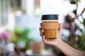 Female hands holding reusable coffee cup,
