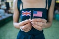 Female hands hold small flags of two countries Royalty Free Stock Photo