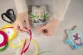 female hands hold a tape and a package. packing of Christmas gingerbread cookies with snowmen on a gray background with