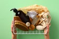 Female hands holding basket with eco friendly bathroom cosmetics