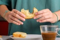 Female hands holding a bitten peanut butter sandwich with honey of wheat bread, have a breakfast