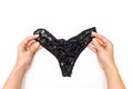 Female hands holding black sexy lacy panties, white background Royalty Free Stock Photo