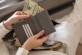 Female hands holding cash money dollars in wallet with cards ready travel vacation or business trip