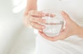 Female hands holding a clear glass of water.A glass of clean mineral water in hands, healthy drink. Royalty Free Stock Photo