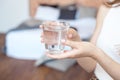 Female hands holding a clear glass of water.A glass of clean mineral water in hands, healthy drink. Royalty Free Stock Photo