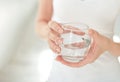 Female hands holding a clear glass of water.A glass of clean mineral water in hands, healthy drink. Royalty Free Stock Photo