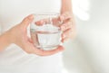 Female hands holding a clear glass of water.A glass of clean mineral water in hands, healthy drink. Royalty Free Stock Photo