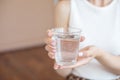 Female hands holding a clear glass of water.A glass of clean mineral water in hands, healthy drink. Royalty Free Stock Photo