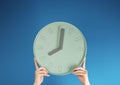 Female hands holding clock on color background. Time management concept Royalty Free Stock Photo