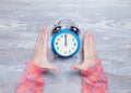 Female hands holding clock Royalty Free Stock Photo