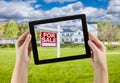 Female Hands Holding Computer Tablet with Home For Sale Sign