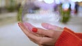 Female hands holding hologram two floored bus