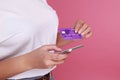 Female hands holding credit card and a touch phone on the table in the office and making a purchase onlain Royalty Free Stock Photo