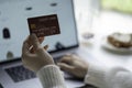 Female hands holding credit card and using laptop. Online shopping Royalty Free Stock Photo