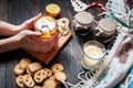 Female hands holding cup black tea with lemon, ginger and cookies on dark wood Royalty Free Stock Photo