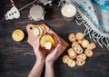 Female hands holding cup black tea with lemon, ginger and cookies on dark wood Royalty Free Stock Photo