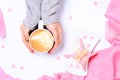 Female hands holding cup of cappuccino. Gift alike dessert with