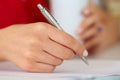 Female hands holding cup of coffee or tea and silver pen closeup Royalty Free Stock Photo