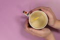 Female hands holding a cup of hot water and lemon Royalty Free Stock Photo
