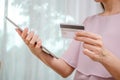 Female hands holding discount credit card in hand paying for shopping online at tablet, Youth casual lifestyle