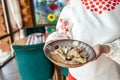 Female hands holding dumplings with cherries and cream sauce, Food recipe background. Close up, top view Royalty Free Stock Photo