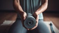 Female hands holding dusty green yoga mat