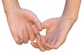 Female hands are holding each other by the thumb