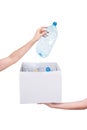 Female hands holding empty crushed blue plastic bottle isolated on white. Recyclable waste. Recycling, reuse, garbage Royalty Free Stock Photo