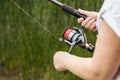 Female hands holding a fishing rod feeder Royalty Free Stock Photo