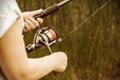 Female hands holding a fishing rod feeder Royalty Free Stock Photo