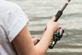 Female hands holding a fishing rod Royalty Free Stock Photo