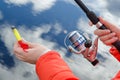 Female hands holding a fishing rod and lure. Royalty Free Stock Photo