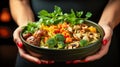 Female hands holding frying pan with meatballs, mushrooms and vegetables on dark background Royalty Free Stock Photo